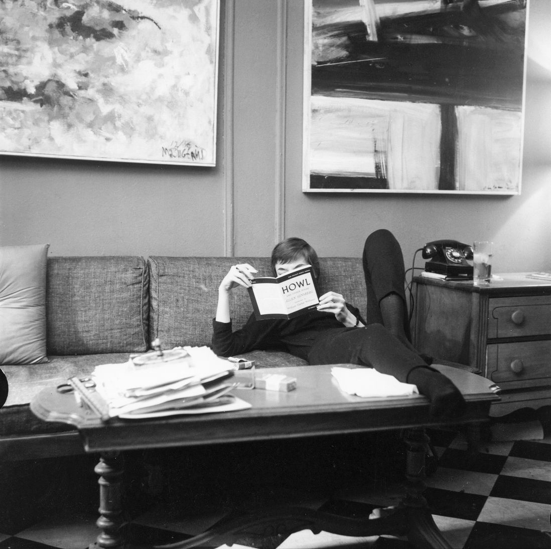 Reading copy of Allen Ginsberg's "Howl" on the couch at Fred W. McDarrah's apartment, 304 West 14th Street, New York City, February 14, 1959<br/>
